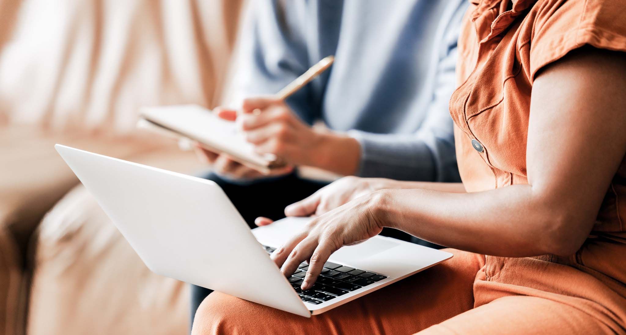 6782172758085-Businesswomen-using-a-laptop-in-an-office